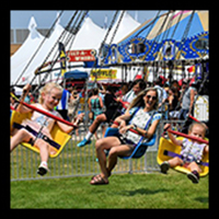 Woman and children on a carnival ride.