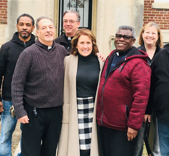 (Left to right) Steve Austin, maintenance supervisor of All Saints Catholic Church; Brother Tom Klein, C.F.A.; Brother Joe Pense, C.F.A., Lydia LoCoco, of the Archdiocese of Milwaukee; Father James Arthur, pastor of All Saints; and Susan McNeil, of the Archdiocese of Milwaukee, gather for a photo after the Brothers agreed to provide ministry staffing for an urban ministry center that the archdiocese plans to open on Milwaukee’s North Side.